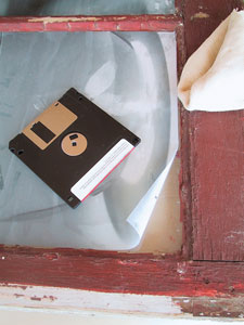 Position print and smooth quickly with your hands. Always work from the center of the picture out to the edge. Using the flat edge of an old computer diskette, smooth the air bubbles out from the center to the edge.